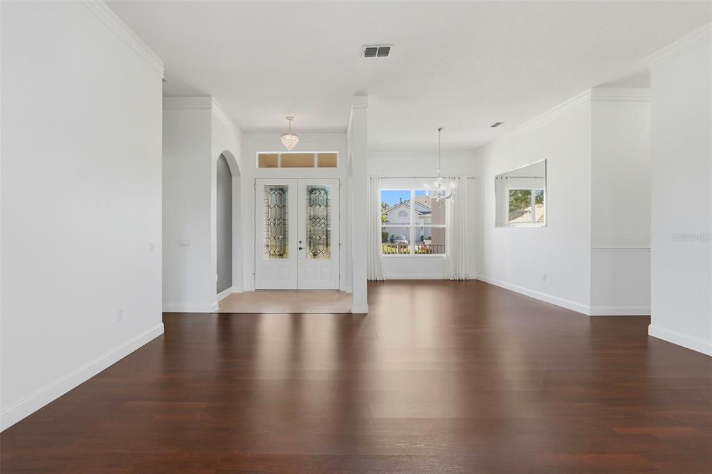 2822 Falcon Ridge Clermont, FL 34711 - Photo 5 of 59 an empty room with wooden floor and windows