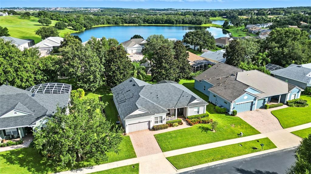 2822 Falcon Ridge Clermont, FL 34711 - Photo 55 of 59 an aerial view of a house with garden space and lake view