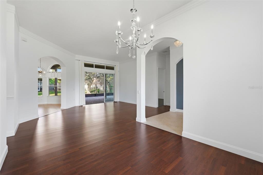 2822 Falcon Ridge Clermont, FL 34711 - Photo 6 of 59 a view of an empty room with wooden floor and a window