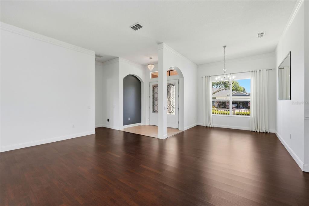 2822 Falcon Ridge Clermont, FL 34711 - Photo 7 of 59 an empty room with wooden floor and windows