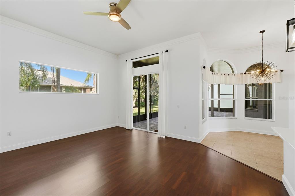 2822 Falcon Ridge Clermont, FL 34711 - Photo 10 of 59 a view of a room with wooden floor chandelier and windows