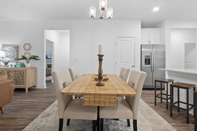 a view of a dining room with furniture and wooden floor