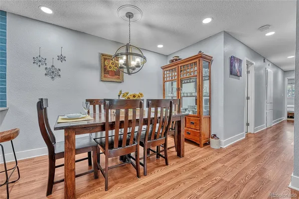 a view of a dining room with furniture wooden floor and chandelier
