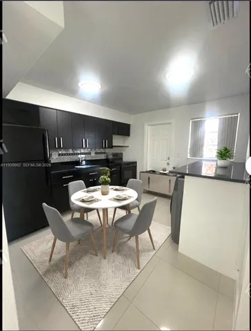 a kitchen with a table and chairs in it