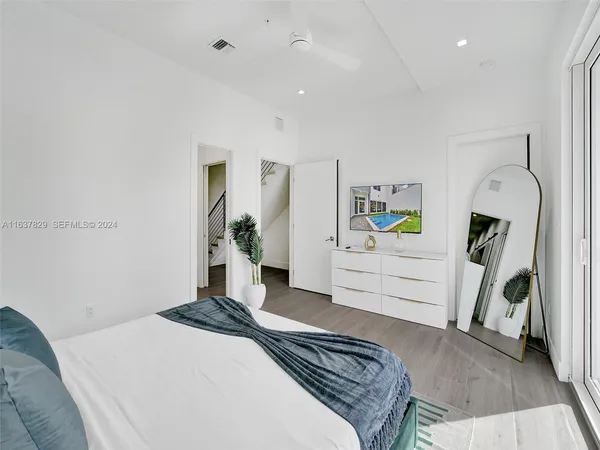 a spacious bedroom with a bed and a large window