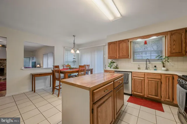 a kitchen with stainless steel appliances a sink stove and cabinets