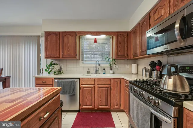 a kitchen with a sink stove top oven and cabinets