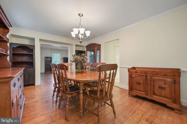 a view of a dining room with furniture wooden floor and chandelier
