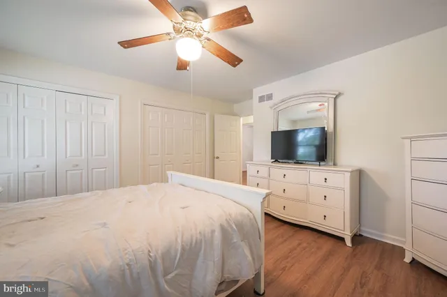 a bedroom with a large bed and a flat screen tv