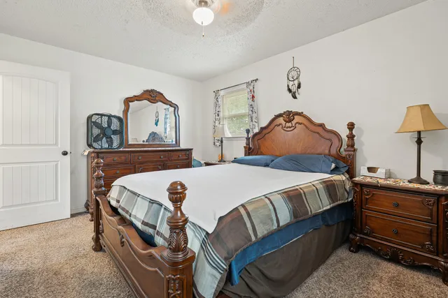 a bedroom with a bed and a dresser