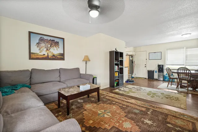 a living room with furniture and a wooden floor