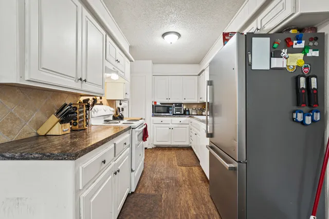 a kitchen with cabinets a sink and appliances