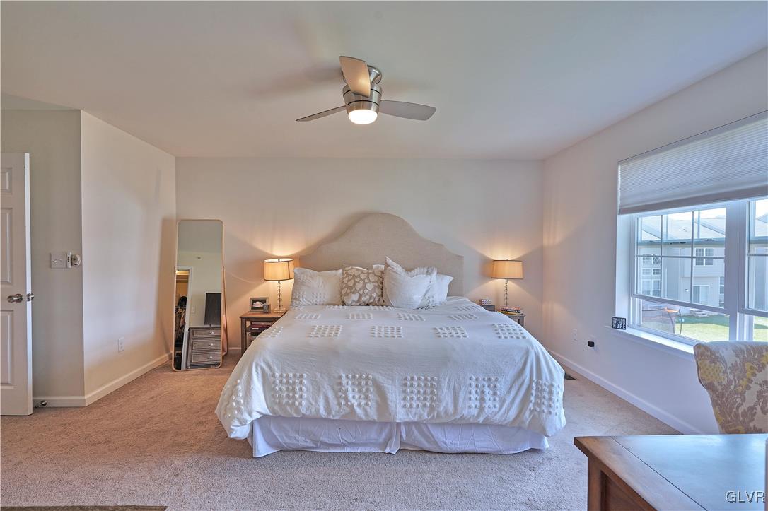 229 Snapdragon Way Allentown, PA 18104 - Photo 17 of 27 a bedroom with a large bed and ceiling fan