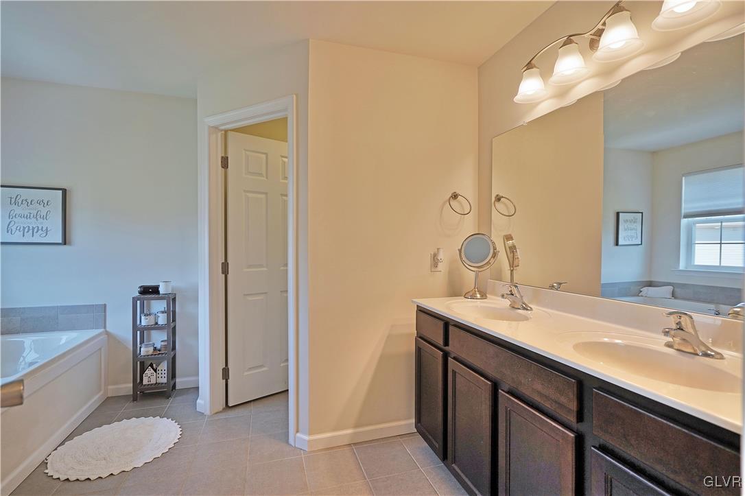 229 Snapdragon Way Allentown, PA 18104 - Photo 19 of 27 a bathroom with a sink a toilet a tub and a mirror