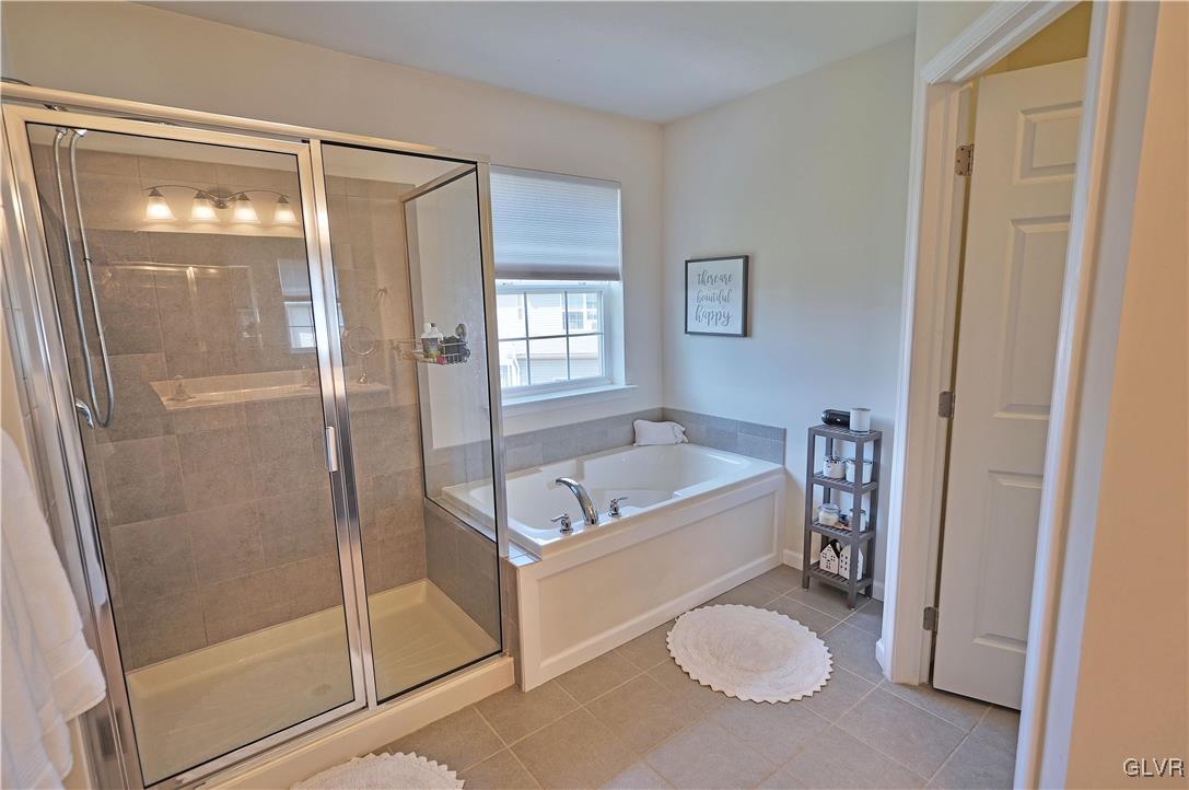 229 Snapdragon Way Allentown, PA 18104 - Photo 20 of 27 a bathroom with a tub and a shower