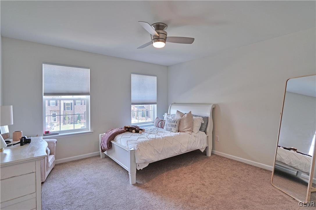 229 Snapdragon Way Allentown, PA 18104 - Photo 22 of 27 a spacious bedroom with a bed a couch and a window