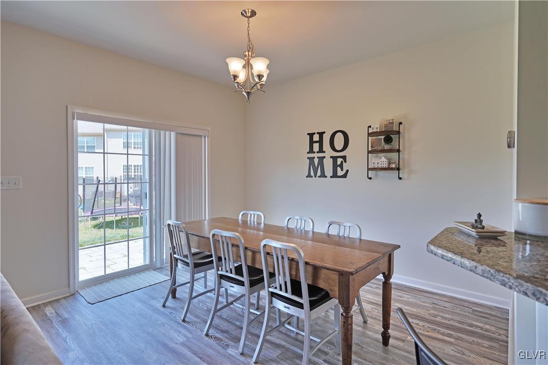 229 Snapdragon Way Allentown, PA 18104 - Photo 9 of 27 a view of a dining room with furniture wooden floor and a chandelier