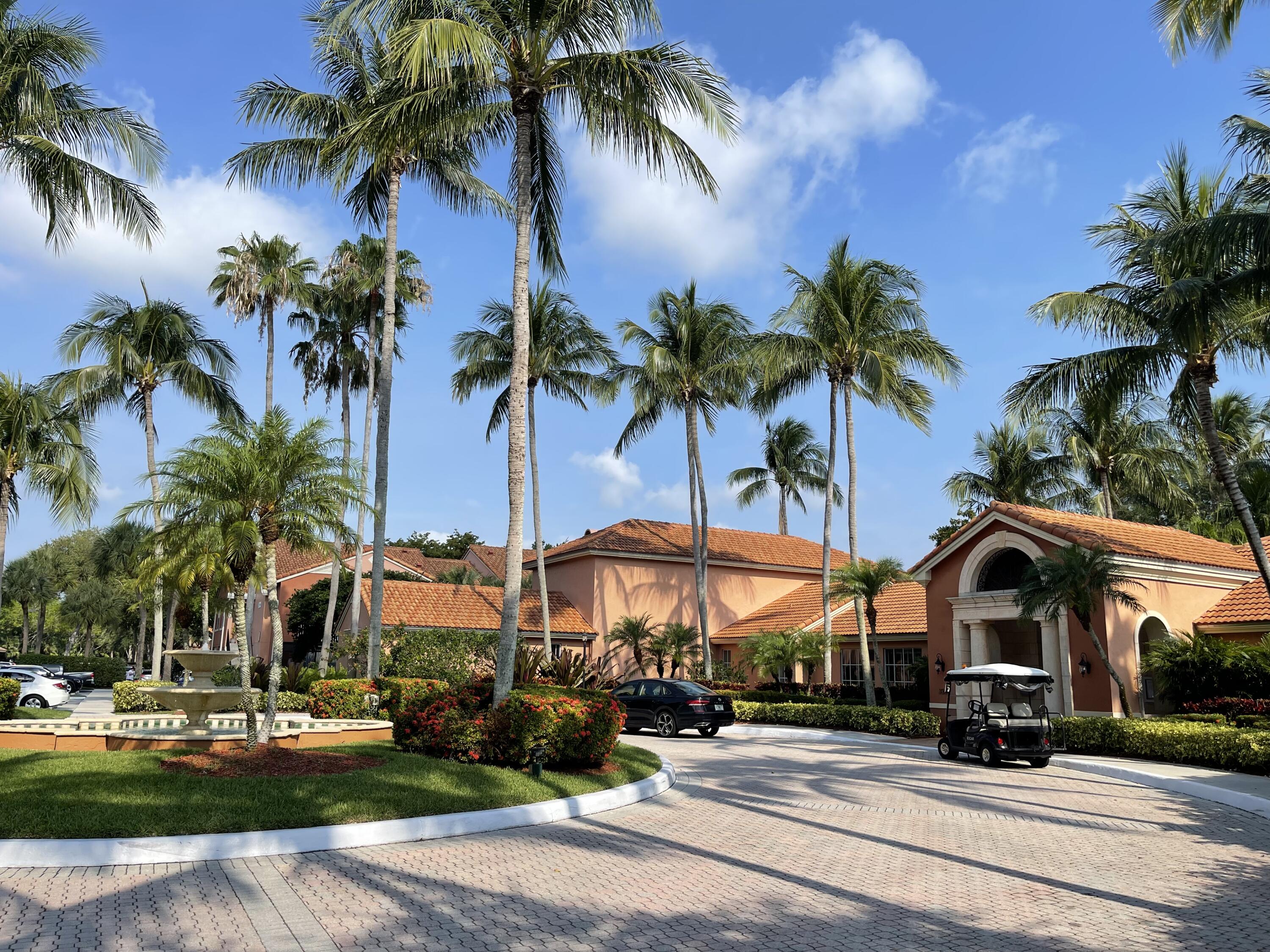 a view of multiple houses with palm trees