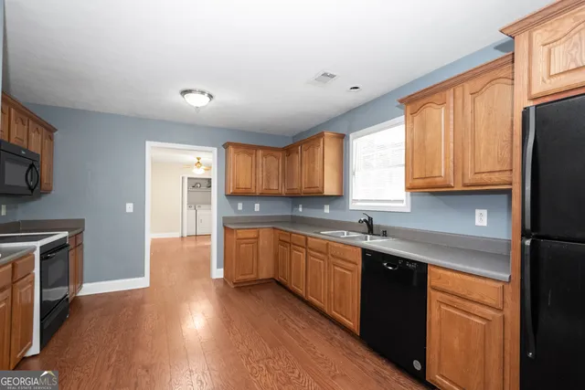 a kitchen with stainless steel appliances granite countertop a stove a microwave and a refrigerator