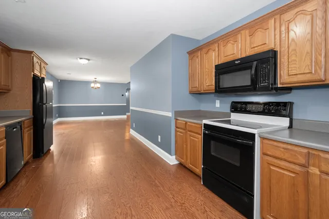 a kitchen with stainless steel appliances a stove microwave and sink