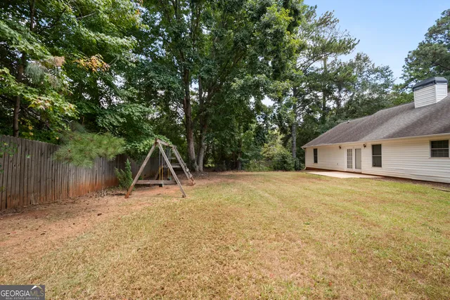 an aerial view of a house with a yard and garden