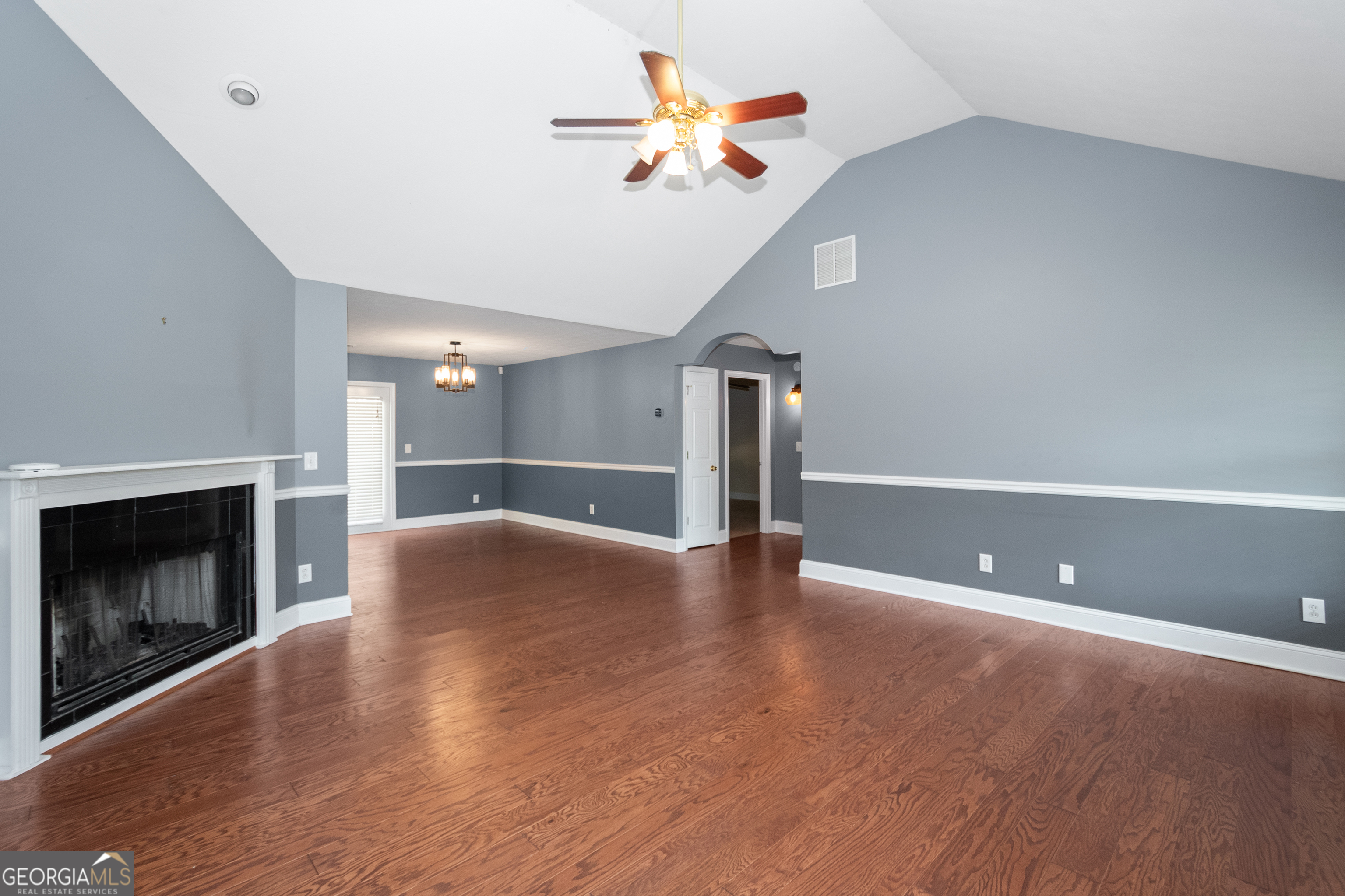 84 Hidden Lakes Court Newnan, GA 30263 - Photo 6 of 35 a view of an empty room with a fireplace and a fan