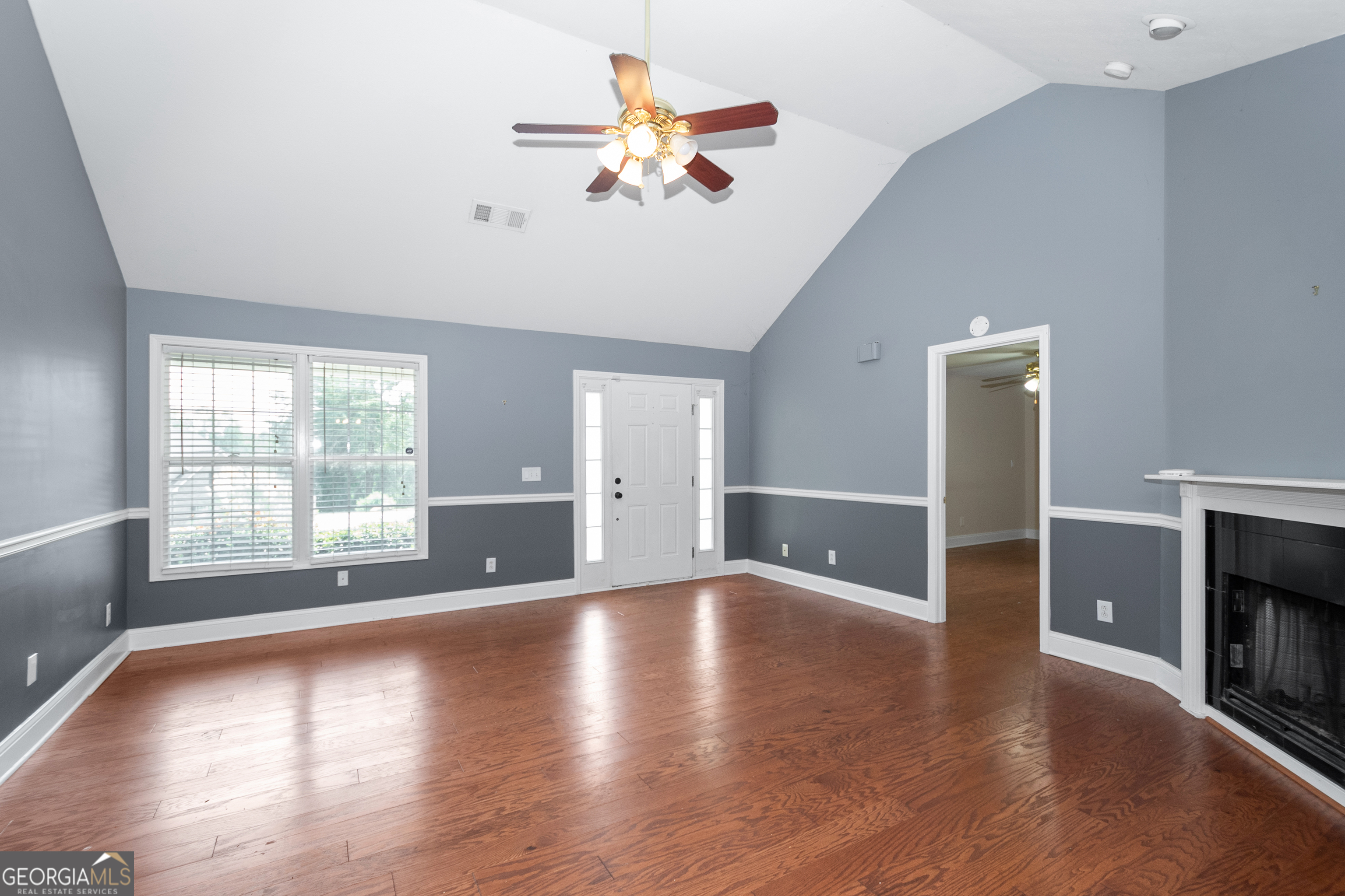 84 Hidden Lakes Court Newnan, GA 30263 - Photo 8 of 35 a view of an empty room with a window and wooden floor