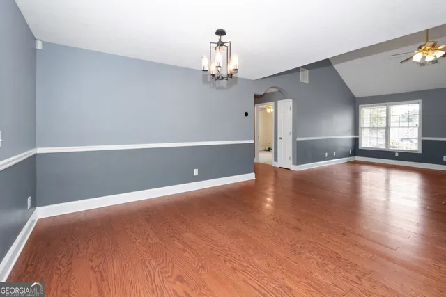 a view of a room with kitchen view and a chandelier