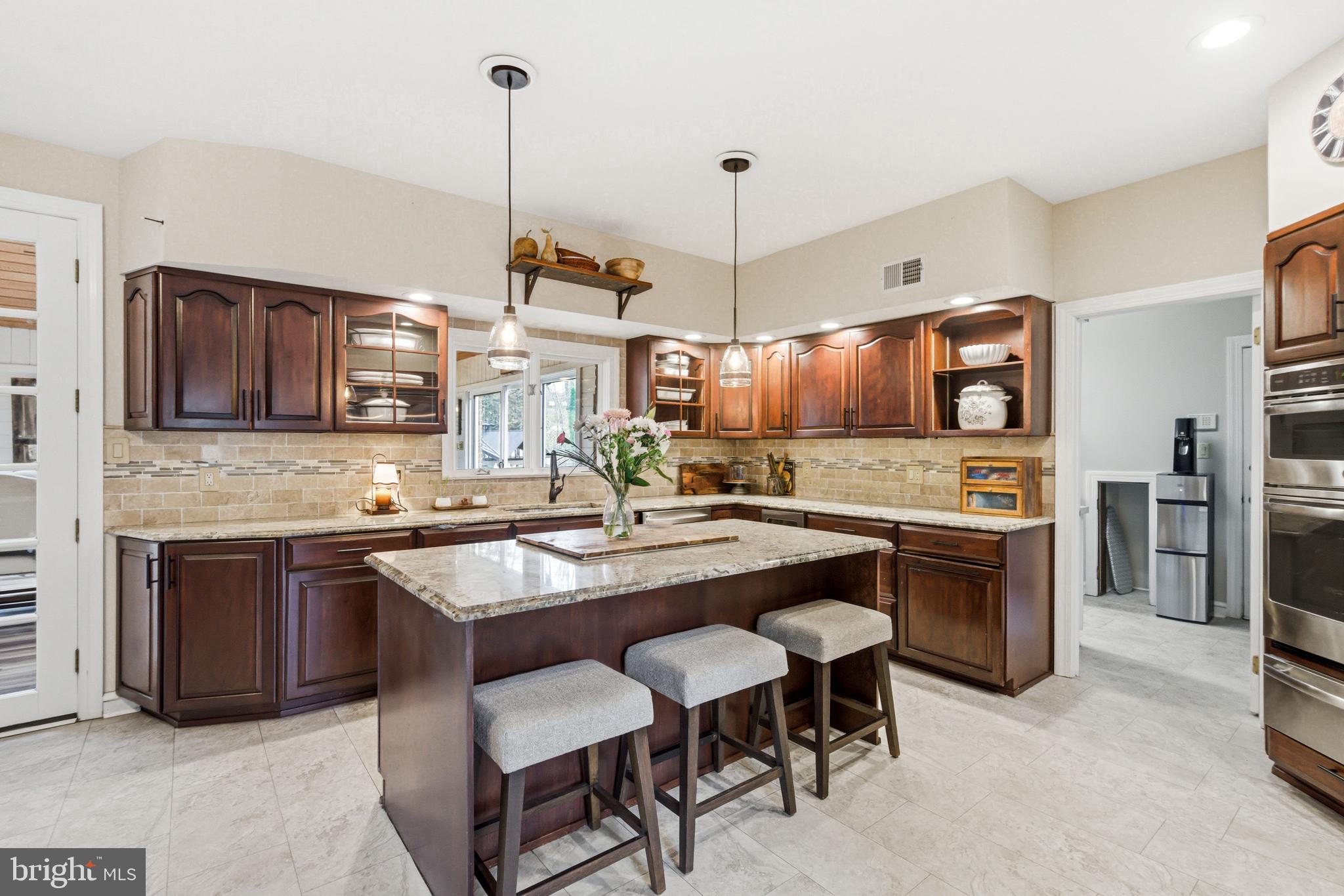 2 Teaberry Drive Medford, NJ 08055 - Photo 12 of 72 a kitchen with stainless steel appliances granite countertop wooden cabinets a stove a sink a oven a dining table and chairs
