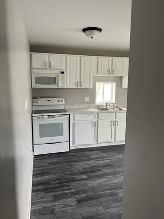 a view of a kitchen with a sink and a stove