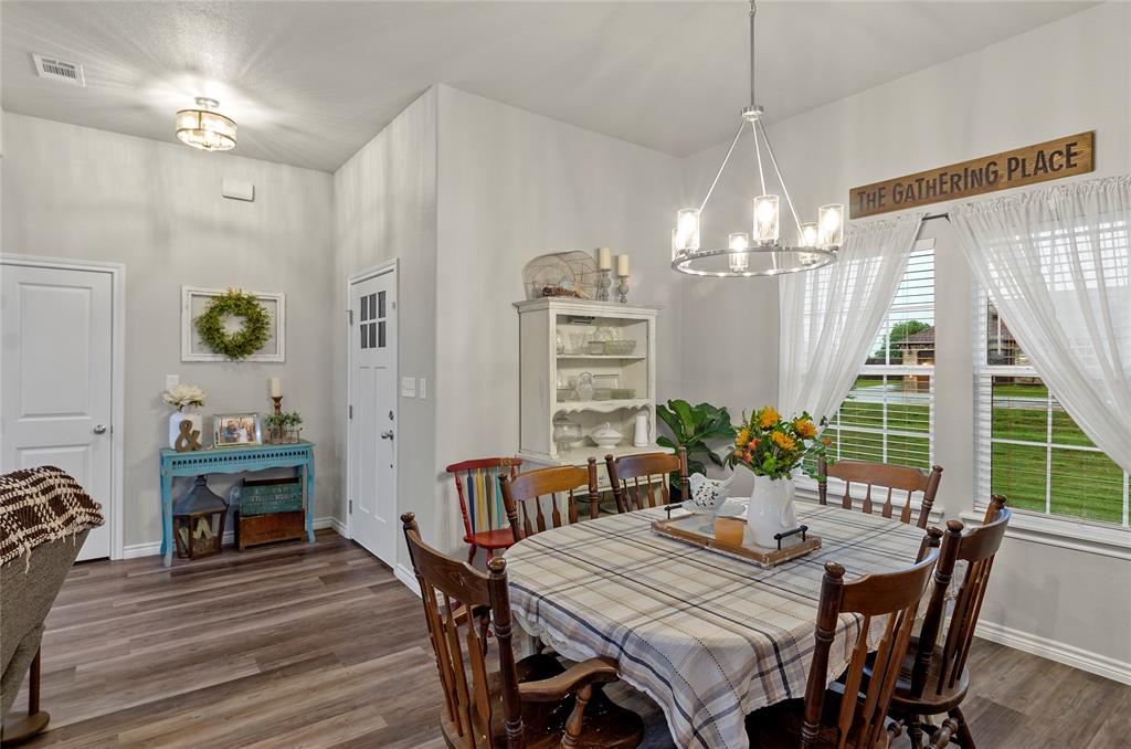 141 Walnut Street Paradise, TX 76073 - Photo 11 of 23 Dining room with suspended lighting and dark wood finished floors