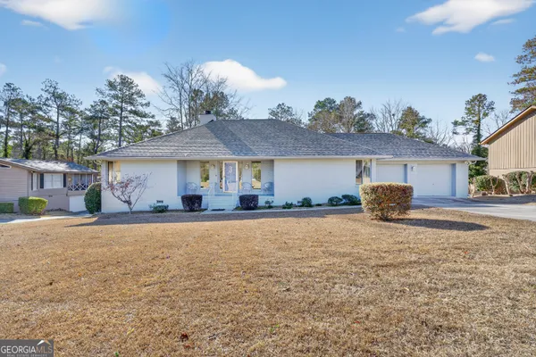 a front view of a house with a yard and porch