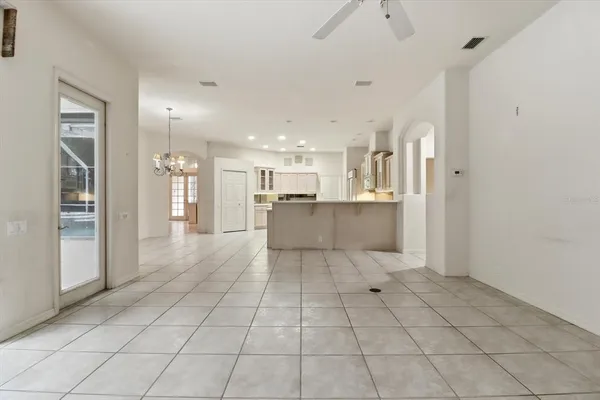 a view of a kitchen with a sink and an empty room