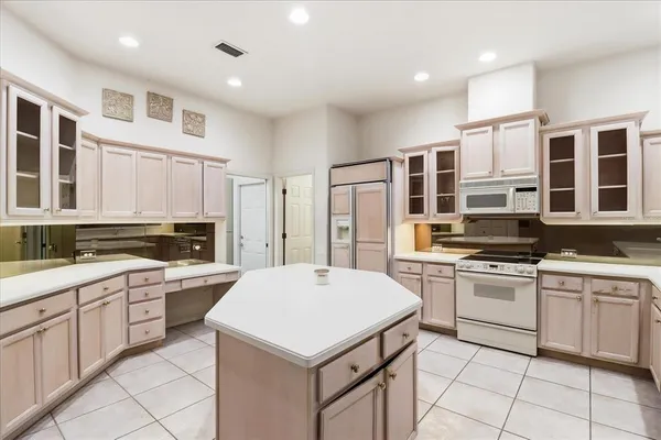 a kitchen with a sink a stove a refrigerator and cabinets