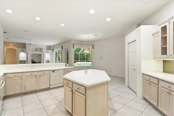 a kitchen with a sink and chairs