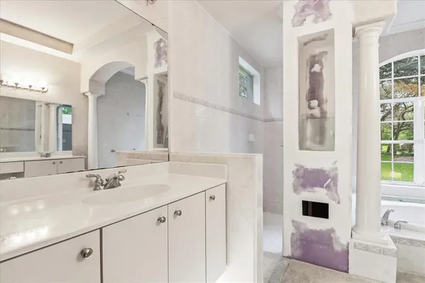 a bathroom with a sink vanity and mirror