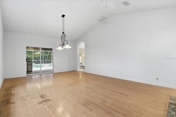 a view of a room with wooden floor and windows