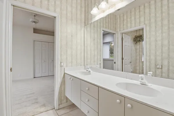 a bathroom with a double vanity sink and mirror