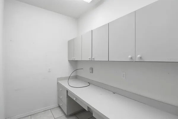 a view of a workspace with furniture and gym equipment