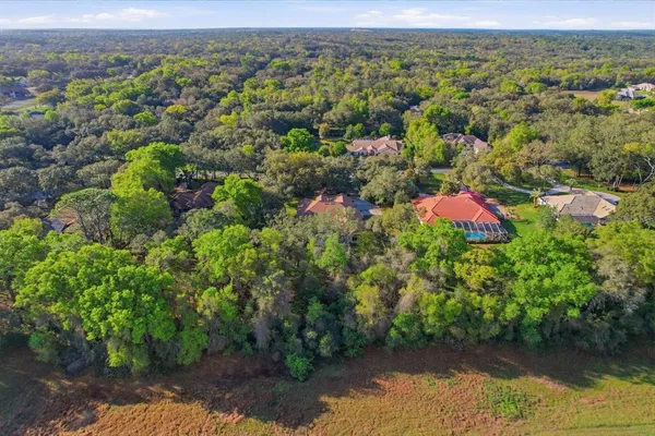 front view of a house with a yard and garden