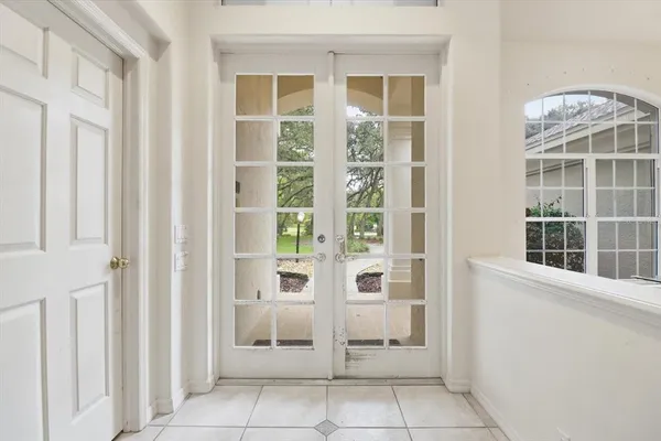 a view of a entrance and room with windows