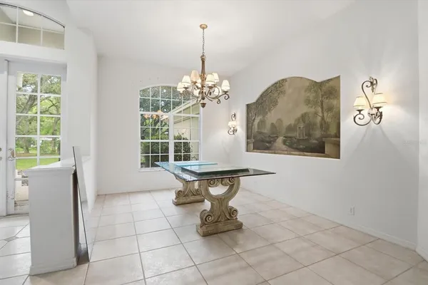 a view of a dining room with furniture and chandelier