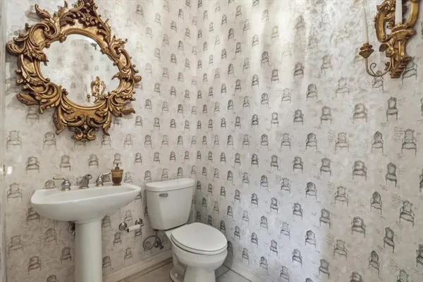 a bathroom with a sink a toilet and mirror