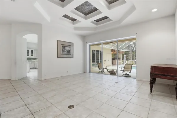 a view of a livingroom with lounge chair and a large window