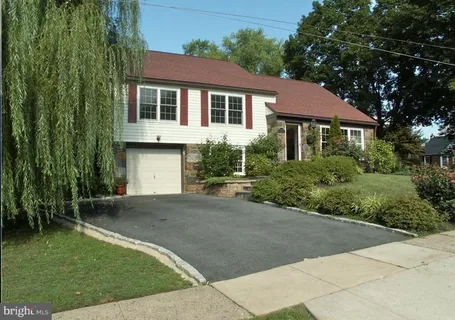 a front view of a house with yard covered in snow