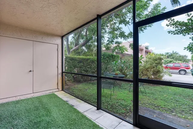 a view of a cars park in front of a building