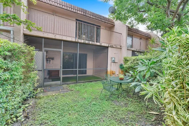 a view of a brick house with potted plants