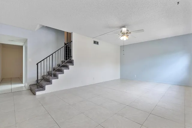 a view of an empty room with stairs