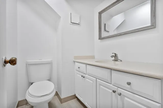 a spacious bedroom with a bed a couch and a large window