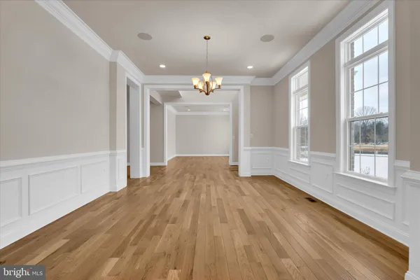 a view of a room with wooden floor and window